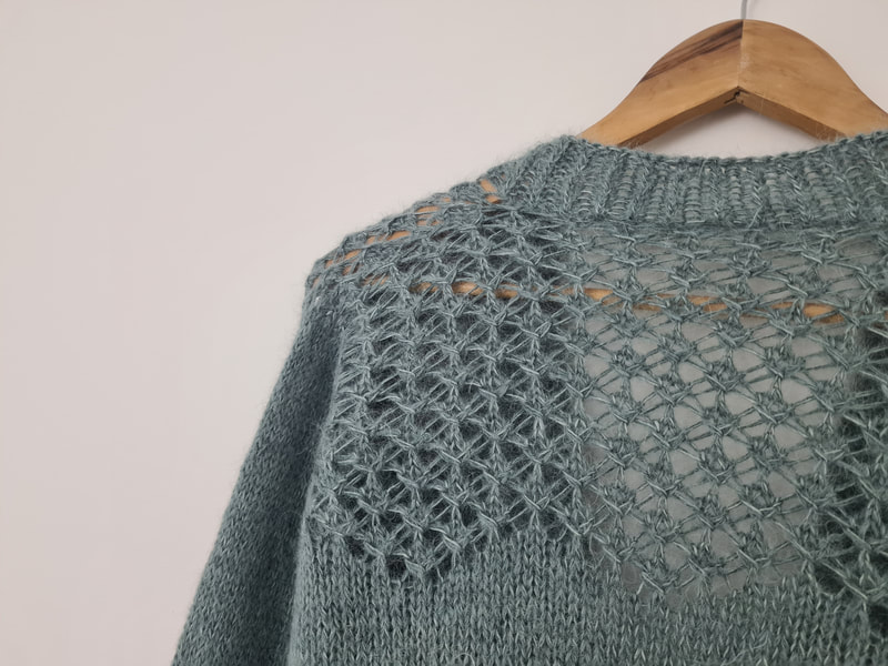 Cardigan knitting pattern, close up of the back shoulders with a zig zag lace design